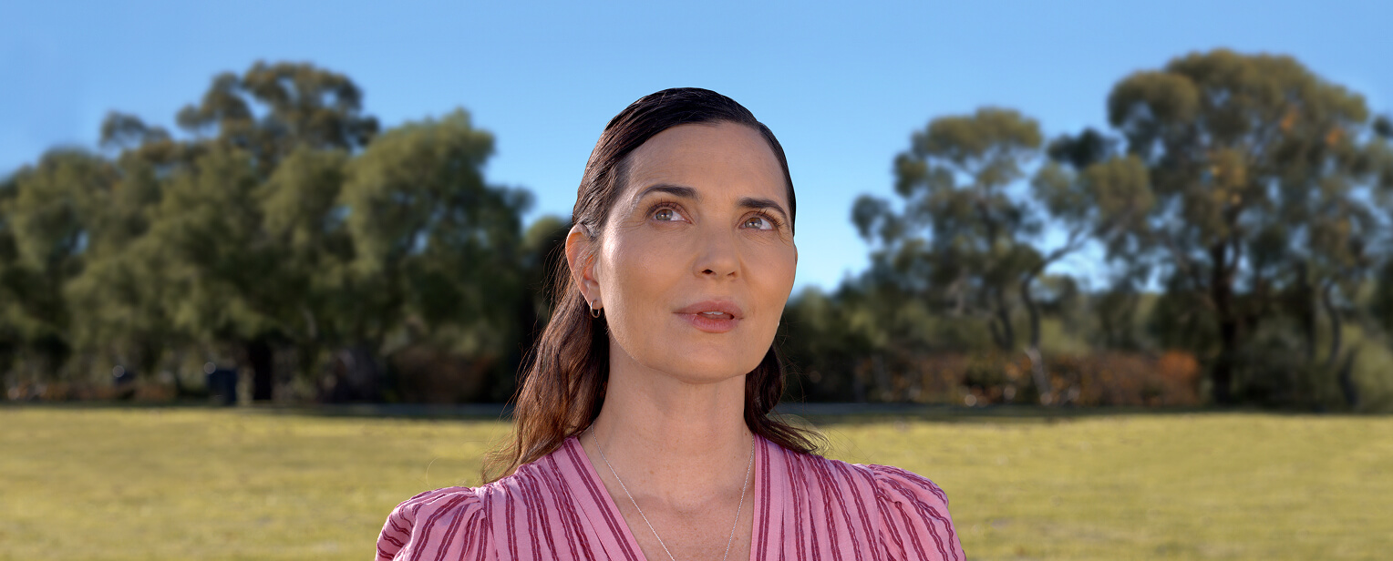 Woman standing outside looking away from the camera Woman standing outside looking away from the camera